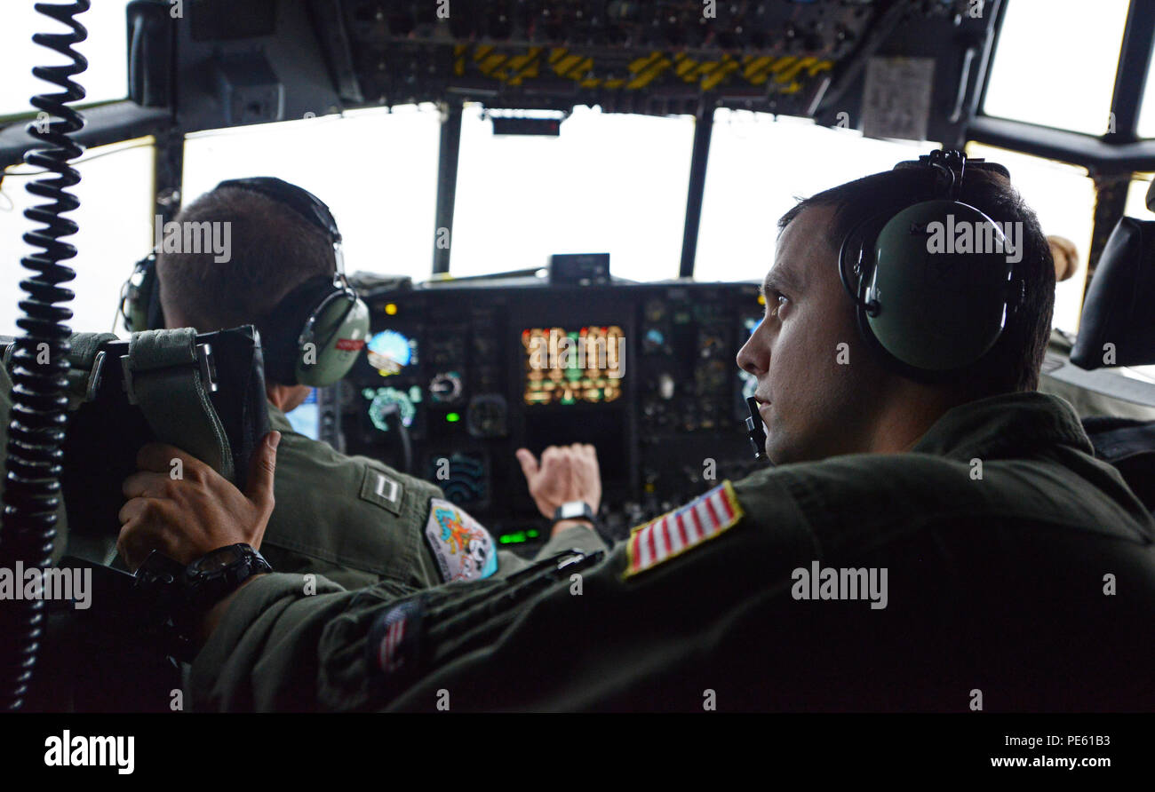 Petty Officer 2nd Class Matthew Morris, an aviation maintenance technician assigned to Coast Guard Air Station Sacramento, keeps an eye on equipment in the cockpit of an HC-130 Hercules aircraft during a fisheries surveillance flight of the Pacific Northwest, Sept. 30, 2015. The flight, which covered territory between the Canadian border and central Oregon, was part of a multi-agency effort to safeguard living marine resources in the Pacific Northwest. (U.S. Coast Guard photo by Seaman Sarah Wilson) Stock Photo