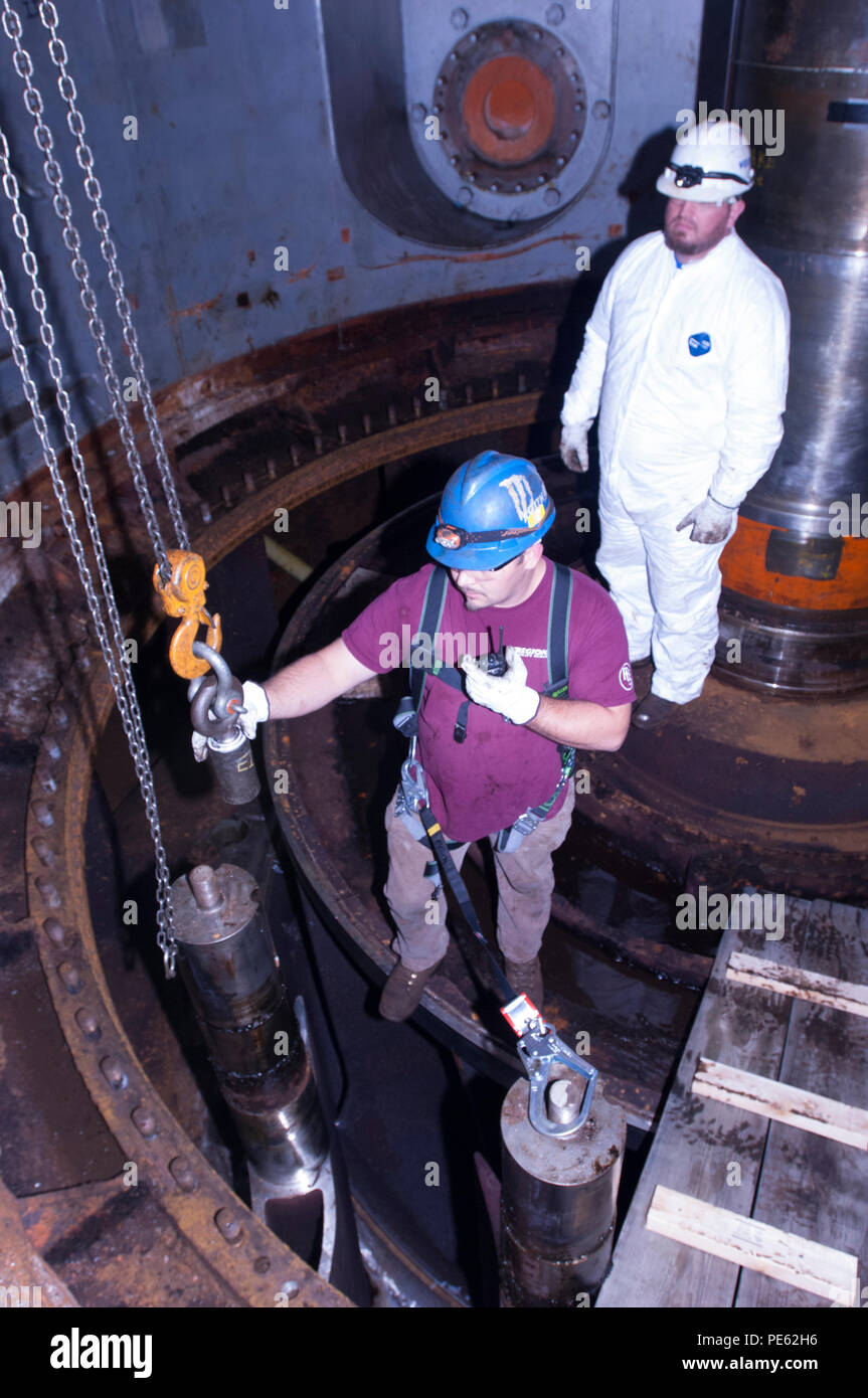 A. J. Conley (Front), turbine mechanic with Voith Hydro, and his supervisor Kye Moss, remove a wicket gate from hydropower unit two in the power house at Center Hill Dam Oct. 7, 2015. The U.S. Army Corps of Engineers Nashville District is rehabbing all three units at the dam. (USACE photo by Leon Roberts) Stock Photo