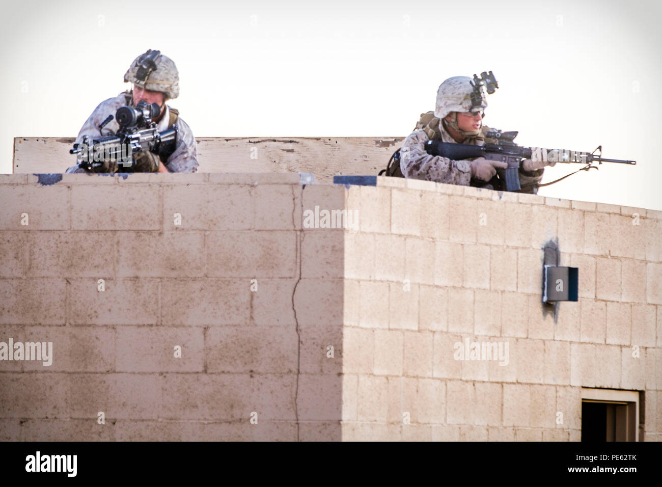 U.S. Marines with 2nd Battalion, 7th Marine Regiment, 1st Marine Division provide security during a heavy Huey raid at K-9 Village, Yuma Proving Grounds, Ariz., Oct. 7, 2015. The exercise is part of Weapons and Tactics Instructor (WTI) 1-16, a seven-week training event hosted by Marine Aviation Weapons and Tactics Squadron One (MAWTS-1) cadre. MAWTS-1 provides standardized tactical training and certification of unit instructor qualifications to support Marine Aviation Training and Readiness and assists in developing and employing aviation weapons and tactics. (U.S. Marine Corps photograph by C Stock Photo