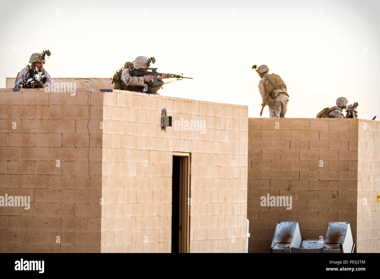 U.S. Marines with 2nd Battalion, 7th Marine Regiment, 1st Marine Division provide security during a heavy Huey raid at K-9 Village, Yuma Proving Grounds, Ariz., Oct. 7, 2015. The exercise is part of Weapons and Tactics Instructor (WTI) 1-16, a seven-week training event hosted by Marine Aviation Weapons and Tactics Squadron One (MAWTS-1) cadre. MAWTS-1 provides standardized tactical training and certification of unit instructor qualifications to support Marine Aviation Training and Readiness and assists in developing and employing aviation weapons and tactics. (U.S. Marine Corps photograph by C Stock Photo