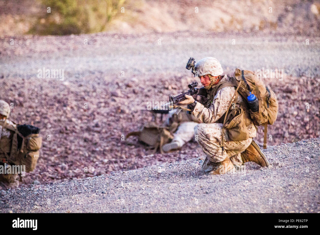 U.S. Marines with 2nd Battalion, 7th Marine Regiment, 1st Marine Division provide security during a heavy Huey raid at K-9 Village, Yuma Proving Grounds, Ariz., Oct. 7, 2015. The exercise is part of Weapons and Tactics Instructor (WTI) 1-16, a seven-week training event hosted by Marine Aviation Weapons and Tactics Squadron One (MAWTS-1) cadre. MAWTS-1 provides standardized tactical training and certification of unit instructor qualifications to support Marine Aviation Training and Readiness and assists in developing and employing aviation weapons and tactics. (U.S. Marine Corps photograph by C Stock Photo