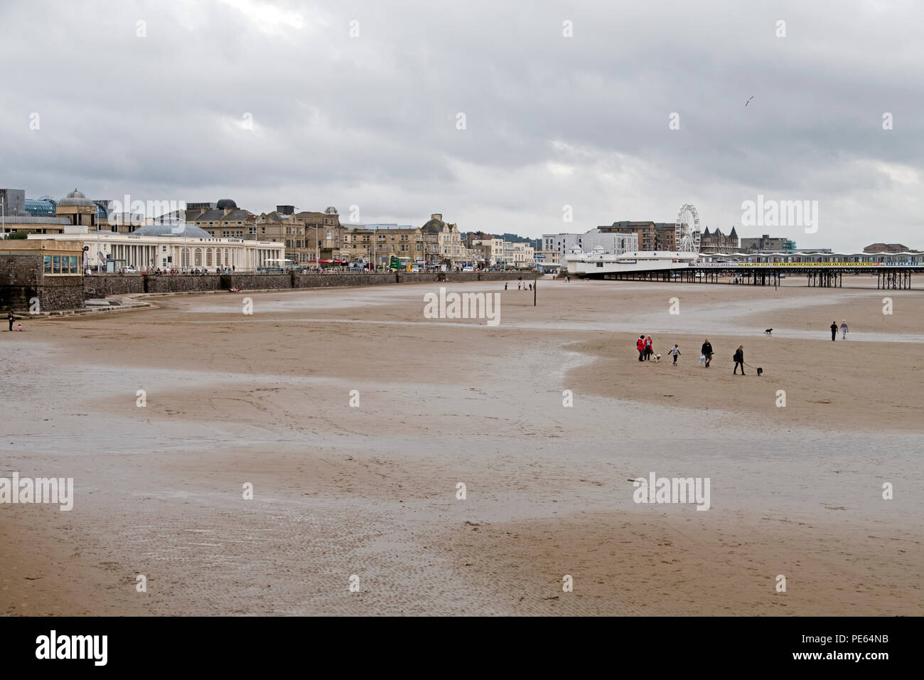 Weston-super-Mare, UK. 12th August, 2018. UK weather: after many hours of rain, a dry but overcast and breezy Sunday afternoon failed to bring many holidaymakers onto the beach, with some of those who did venture out wearing coats. Keith Ramsey/Alamy Live News Stock Photo