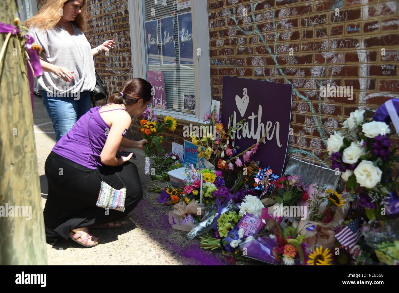(180812) -- WASHINGTON, Aug. 12, 2018 (Xinhua) -- People pay condolences to Heather Heyer at the street corner where she was killed in Charlottesville, Virginia, the United States, on Aug. 10, 2018. A year after a white nationalist rally traumatized Charlottesville, in the U.S. state of Virginia, with riots and blood, the city is still healing from the shock. On Aug. 12, 2017, white supremacists and members of other hate groups gathered in Charlottesville for a self-styled "Unite the Right" rally to protest against the city's decision to remove a Confederate statue before clashing violently wi Stock Photo