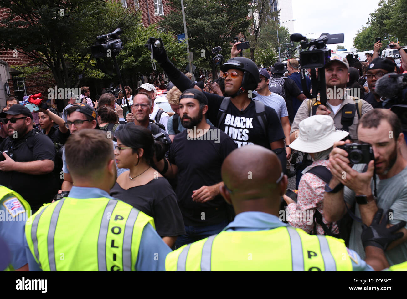 Washington, DC, USA. 12 Aug 2018. Counterprotestors at the Unite the Right protest march in front of the police escort. Credit: Joseph Gruber/Alamy Live News Stock Photo