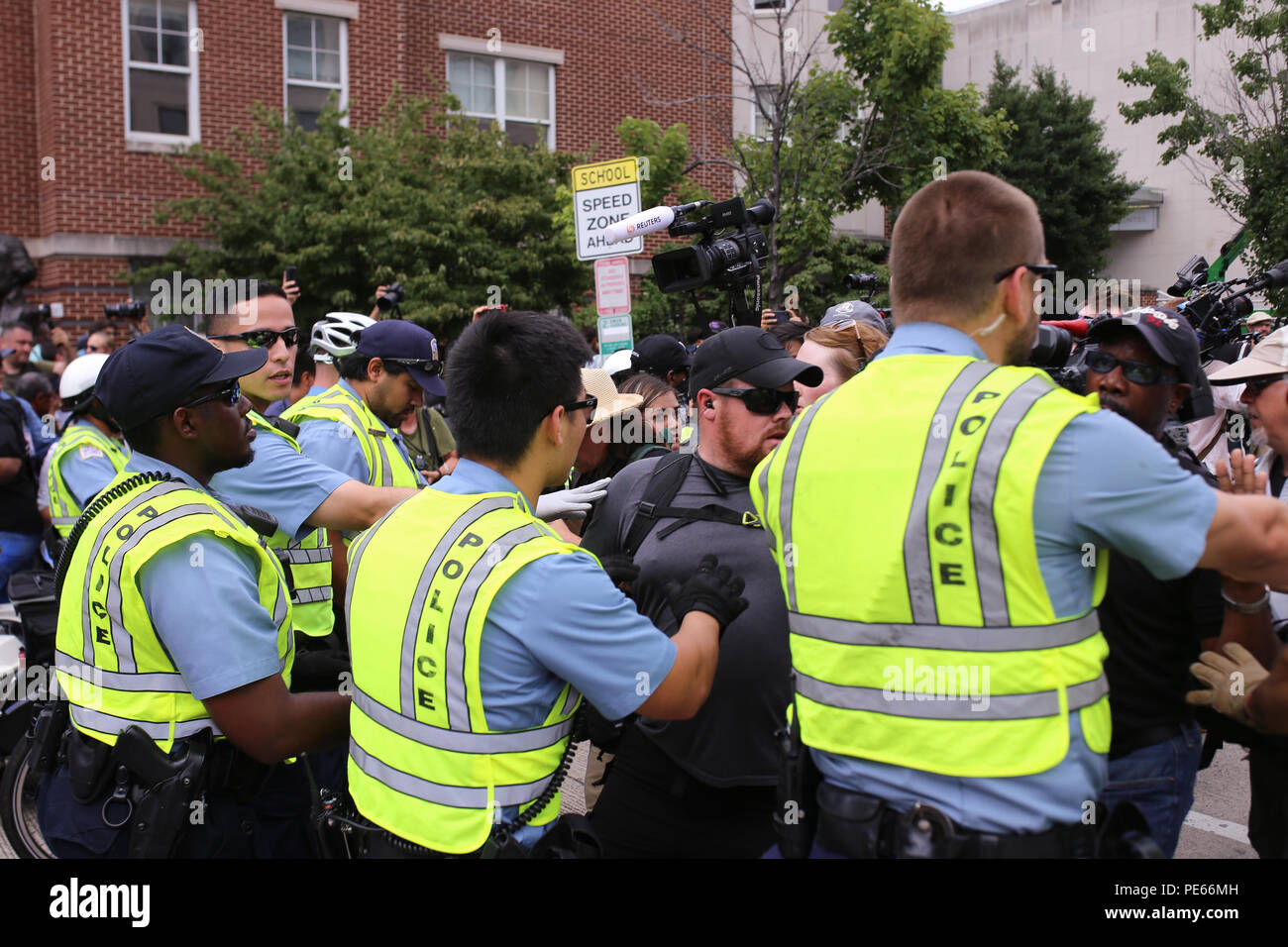 Washington, DC, USA. 12 Aug 2018. Police push back counterprotestors at the front of the escort for Unite the Right protestors. Credit: Joseph Gruber/Alamy Live News Stock Photo