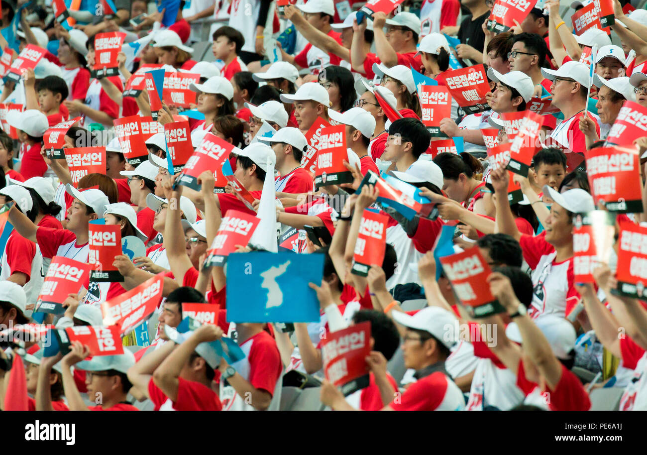 Inter-Korean workers' soccer match, Aug 11, 2018 : South Korean students, workers and citizens cheer during an inter-Korean workers' friendly soccer match at the Seoul World Cup Stadium in Seoul, South Korea. North Korean workers from the General Federation of Trade Unions of (North) Korea and South Korean workers from two umbrella labor unions, the Federation of Korean Trade Unions (FKTU) and the Korean Confederation of Trade Unions (KCTU), participated in the Inter-Korean Laborers' Unification Soccer Competition on Saturday. The soccer match is the fourth of its kind, following ones in Pyong Stock Photo