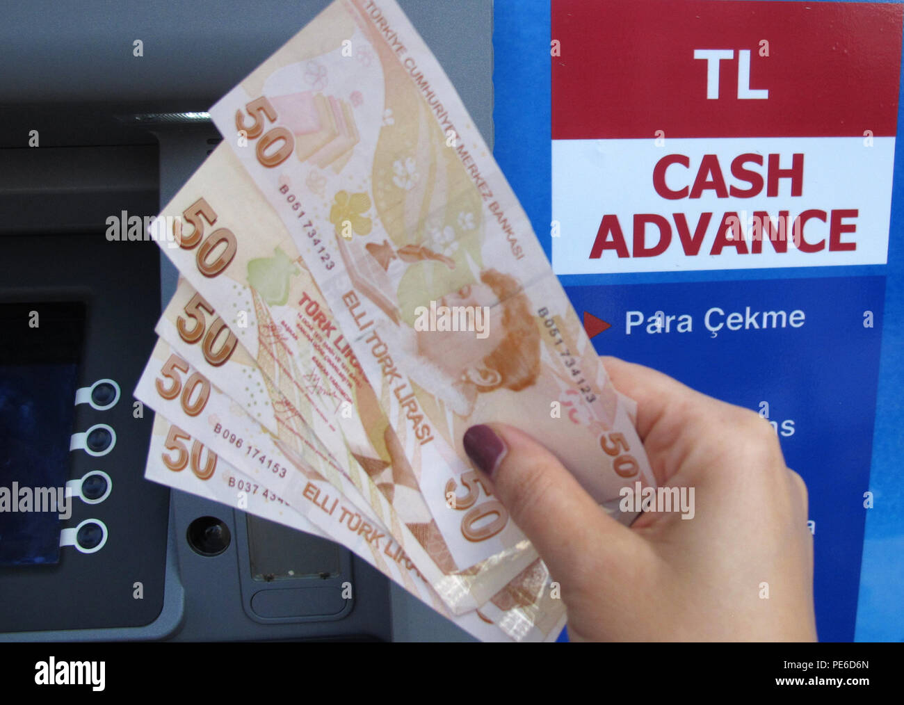 Kas, Turkey. 26th Sep, 2013. (ILLUSTRATION) A woman holds 250 Turkish Lira in bank notes at a cash machine in Kas, Turkey, 26 September 2013. Credit: Jens Kalaene | usage worldwide/dpa/Alamy Live News Stock Photo