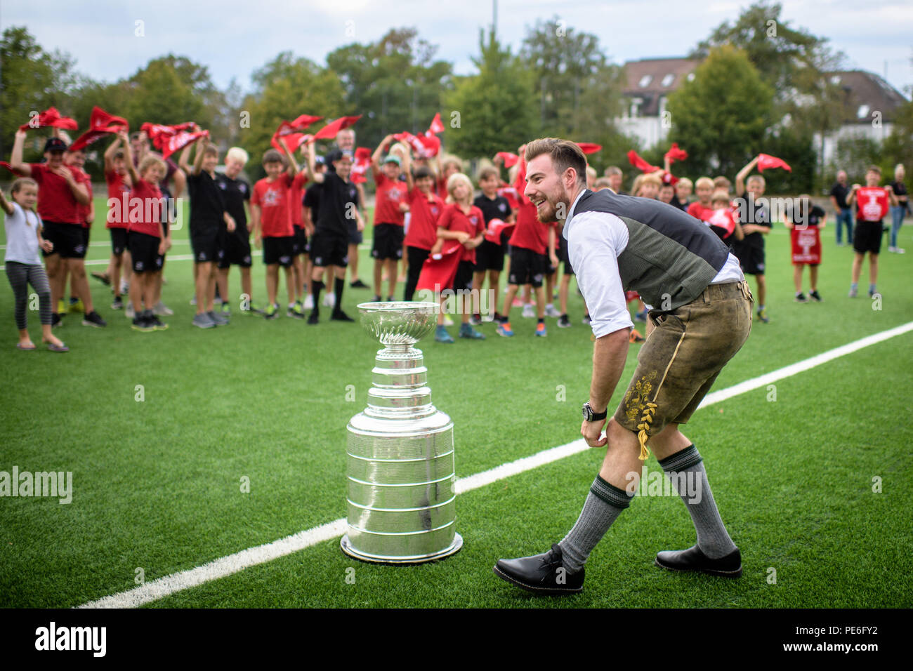 Rosenheim, Bavaria. 13th Aug, 2018. Philipp Grubauer, Stanley Cup winner with the Washington Capitals, will be welcomed with the ice hockey trophy at emilo Stadium by players of the Starbulls Rosenheim ice hockey teams. Born in Rosenheim, he was the first German goalkeeper to win the North American League title. Credit: Matthias Balk/dpa/Alamy Live News Stock Photo
