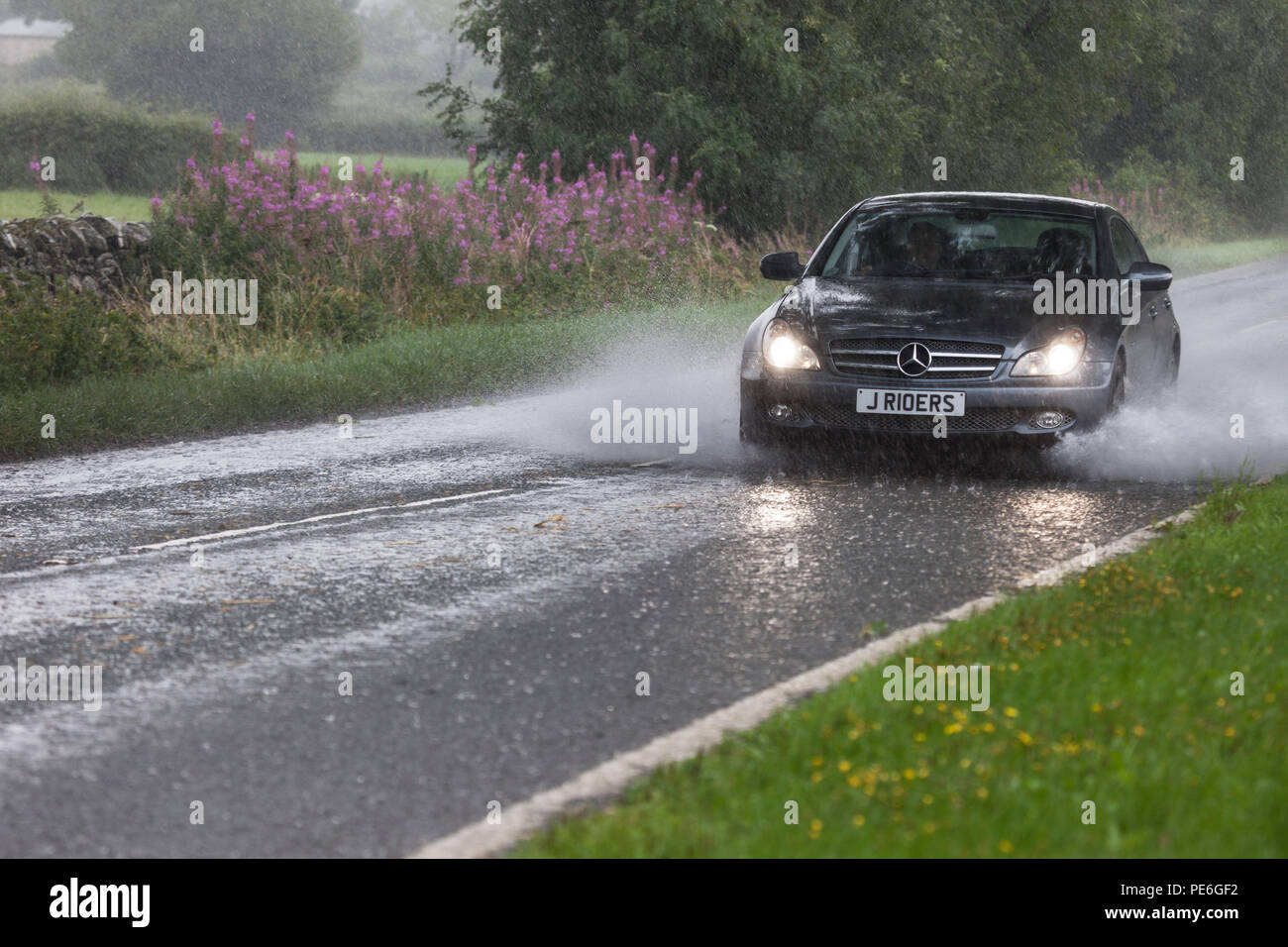 Barnard Castle, Teesdale, County Durham, UK.  Monday 13th August 2018.  UK Weather.  Torrential rain has flooded some roads in the area around Barnard Castle this afternoon, creating hazardous driving conditions. Credit: David Forster/Alamy Live News Stock Photo