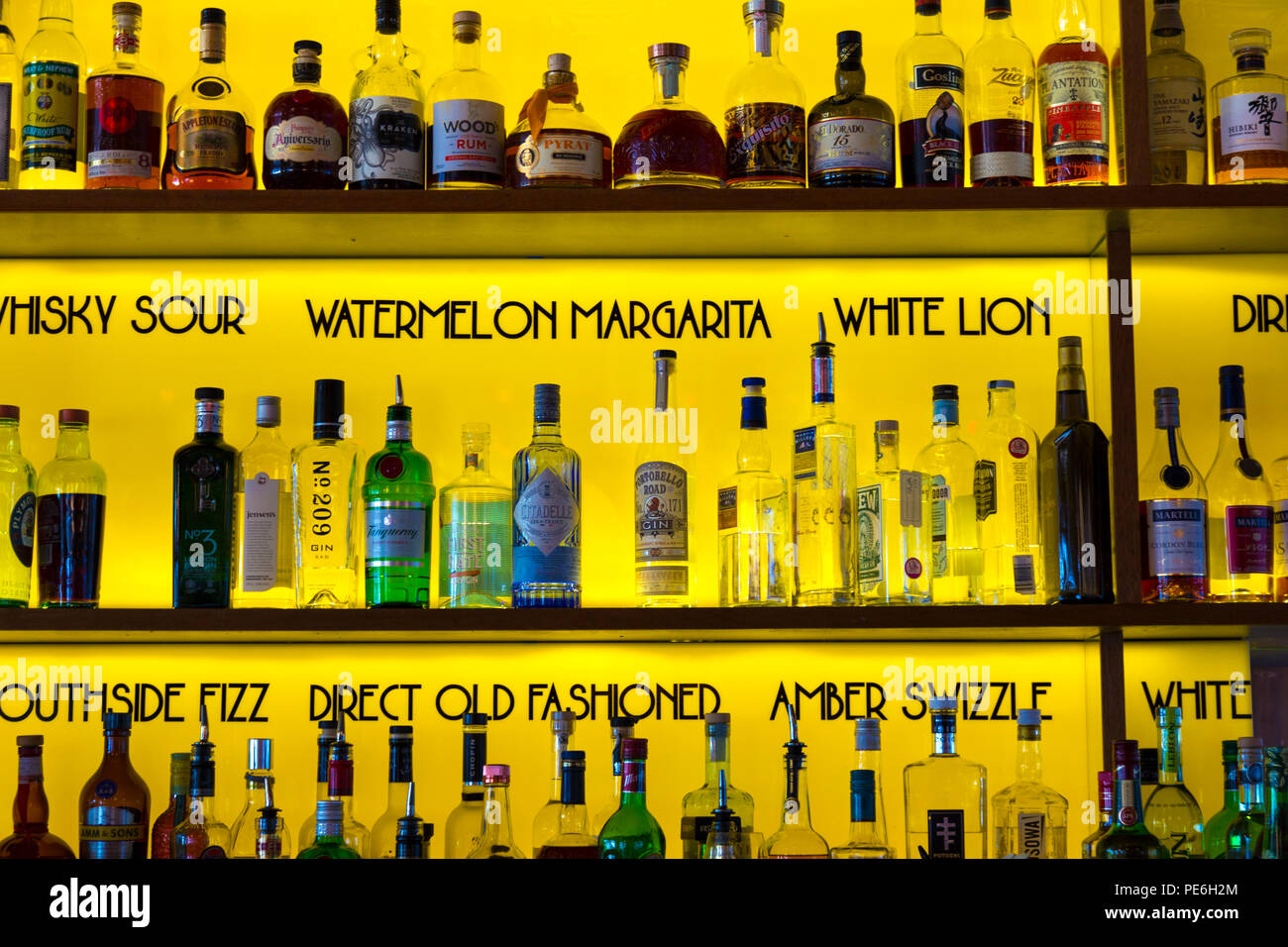 Rows of alcohol bottles on shelves behind a bar counter (Giant Robot, London, UK) Stock Photo