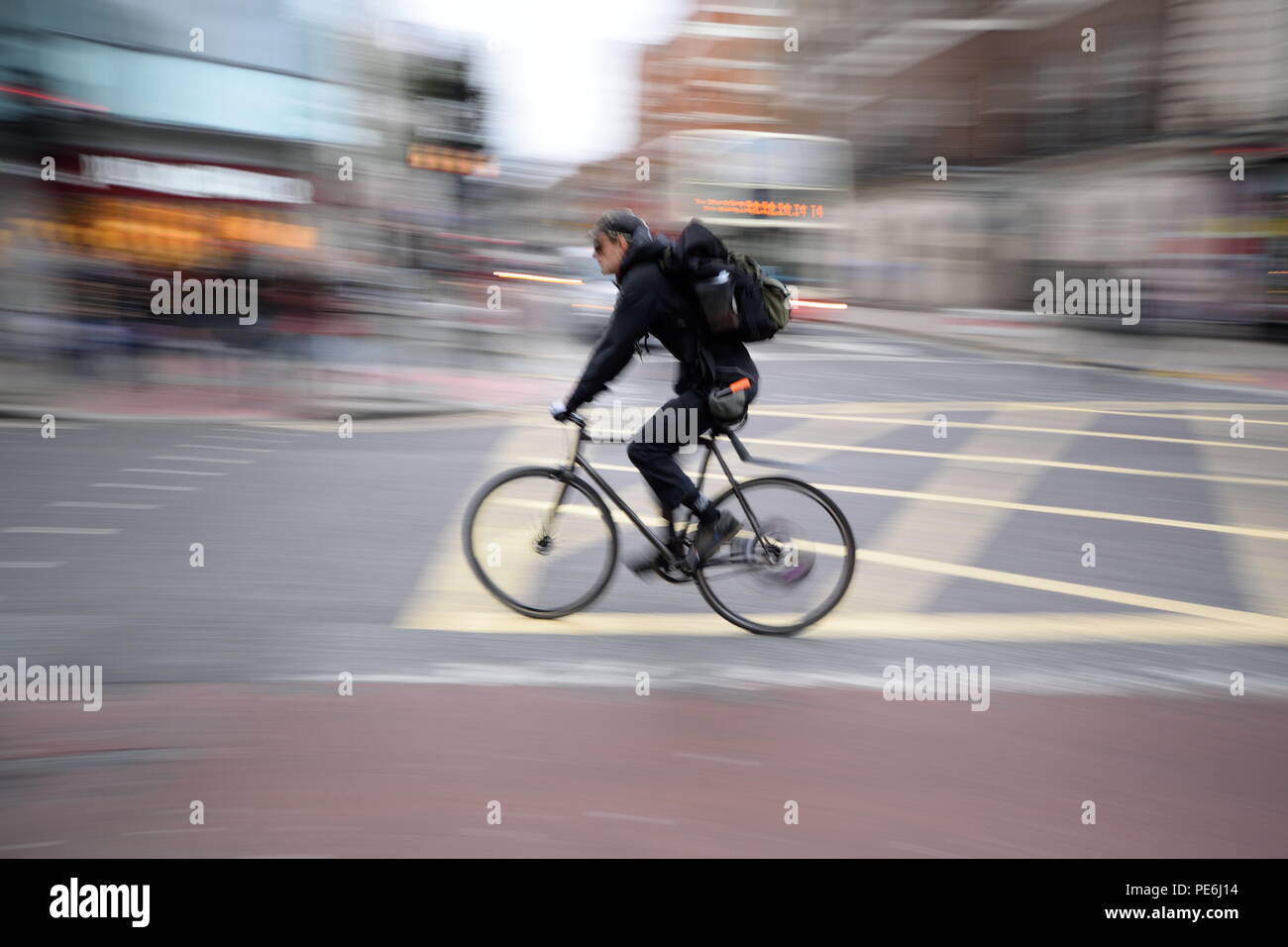 Bicyclist in rush on the street of London with blurred background Stock Photo
