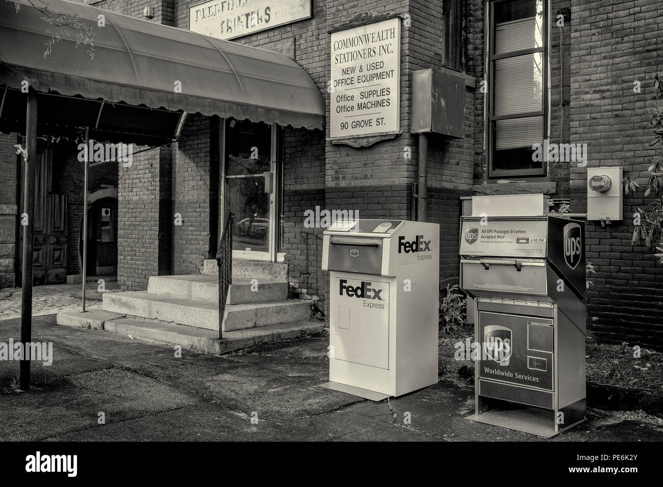 Two mailing boxes - UPS and FEDEX - in front of Commonwealth Stationers on Grove Street in Worcester, MA Stock Photo