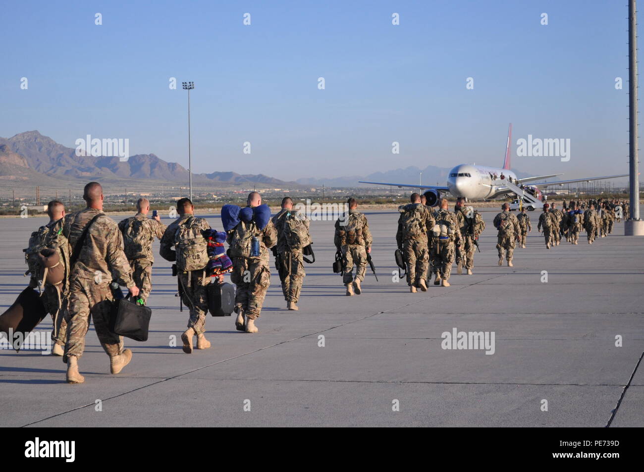 Soldiers assigned to the 155th Engineer Company board the airplane that will take them to the Middle East on a nine-month deployment, the unit departed the Silas L. Copeland Arrival Departure Air Control Group Airfield Oct. 1. Stock Photo
