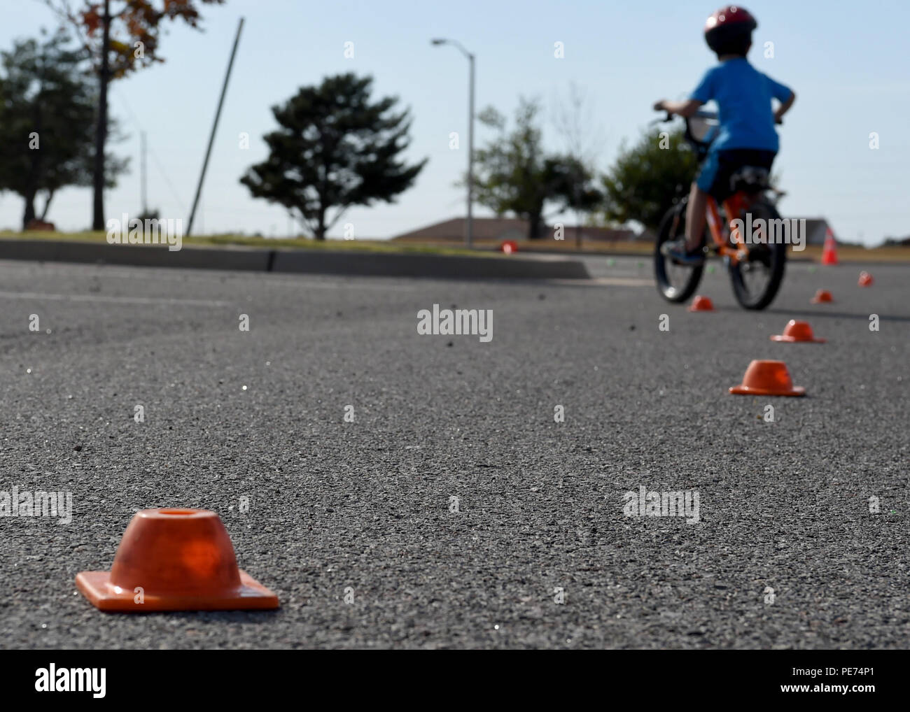 A child rides a bike through an obstacle course during a children’s