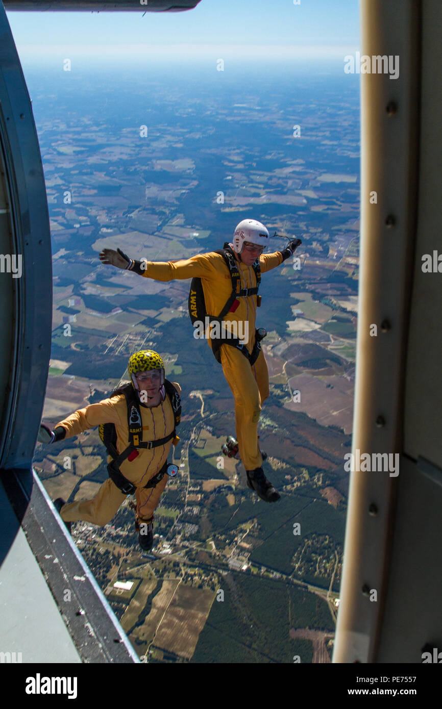 Golden Knights candidates Staff Sgt. Nicholas Berkner (left) and Spc. Joe  Bradshaw (right) exit a UV-18 Twin Otter aircraft over Laurinburg, N.C., to  practice a skydiving maneuver called diamond tracking during tryouts