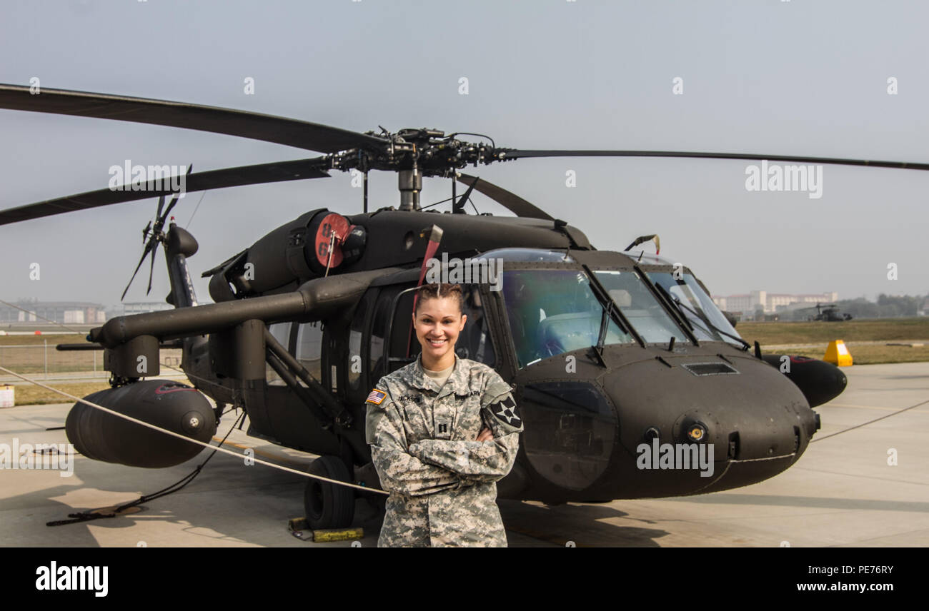Capt. Cydnia Jackson, a senior human resource advisor for the 3rd General Support Aviation Battalion, stands in front of a UH-60 Black Hawk Oct. 22 at the flight line on Camp Humphreys, South Korea. Jackson was selected as one of the top 12 singers in the Operation Rising Star competition. Stock Photo