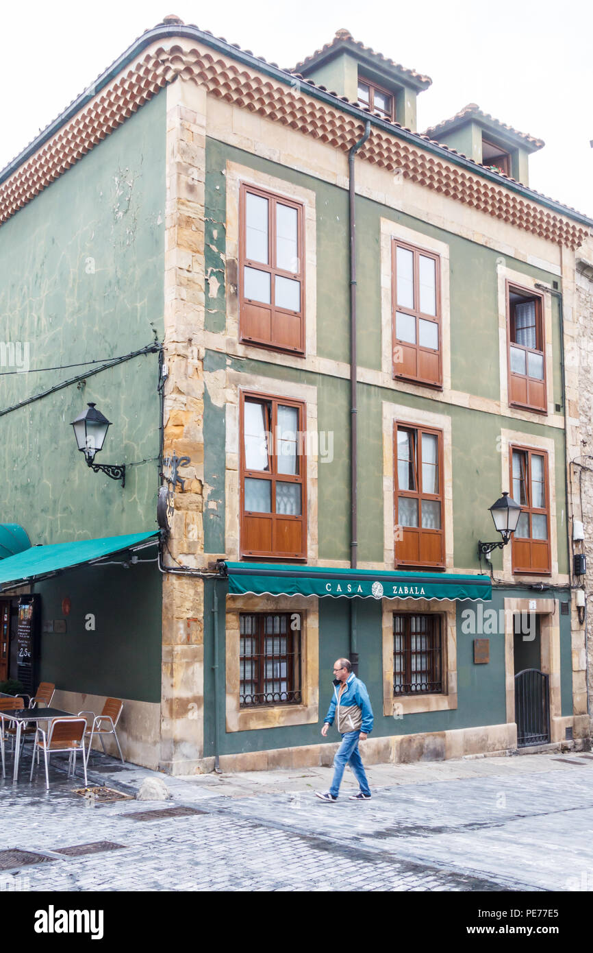 Gijon, Spain - 6th July 2018: Man walks past Casa Zabala in the old fishermans quarter. The area is known as Cimadevilla Stock Photo