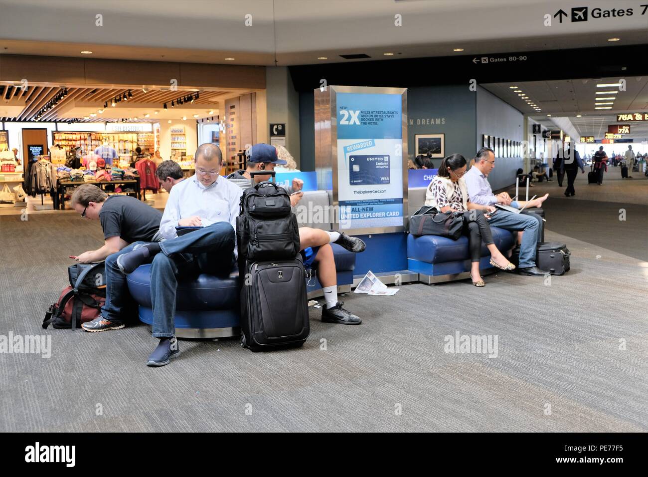 Airport passengers sitting hi-res stock photography and images - Alamy