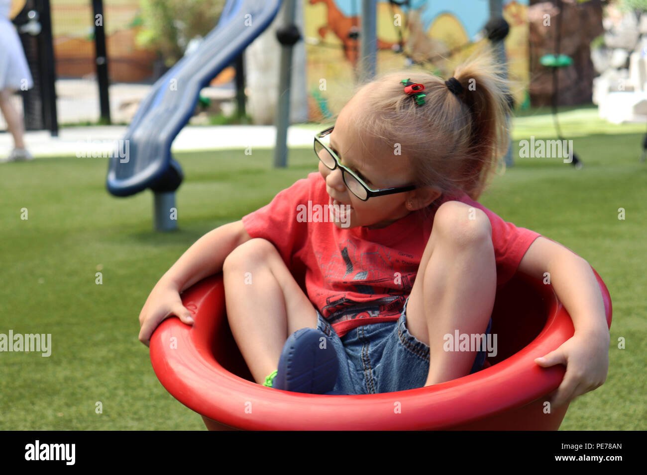 Little girl enjoying herself at the playground Stock Photo