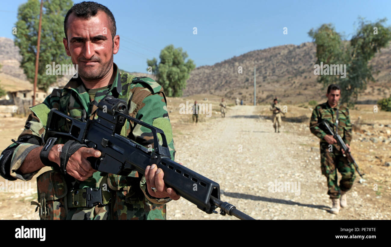 Peshmerga soldiers advance forward in a staggered formation during react-to-contact training near Erbil, Iraq, Oct. 13, 2015. The Peshmerga are part of the Kurdish Security Forces under the Kurdistan Regional Government, a member of 60-plus nation coalition fighting to defeat the Islamic State of Iraq and the Levant. The English translation for “Pershmerga” means, “One who confronts death.” (U.S. Army photo by Spc. Tristan Bolden/Released) Stock Photo