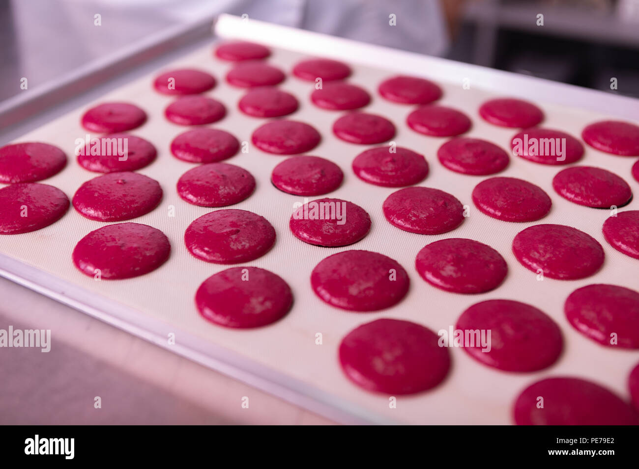 Macaroons Pan Close up of baking pan covering with parchment paper and macaroons ...