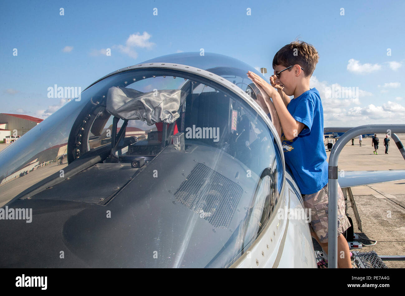Brady Hoffmeyer looks inside the cockpit of a T-38 during the 2015 Joint Base San Antonio Air Show and Open House Nov. 1, 2015, at JBSA-Randolph, Texas. Air shows allow the Air Force to display the capabilities of our aircraft to the American taxpayer through aerial demonstrations and static displays and allowing attendees to get up close and personal to see some of the equipment and aircraft used by the U.S. military today. (U.S. Air Force photo by Johnny Saldivar) Stock Photo