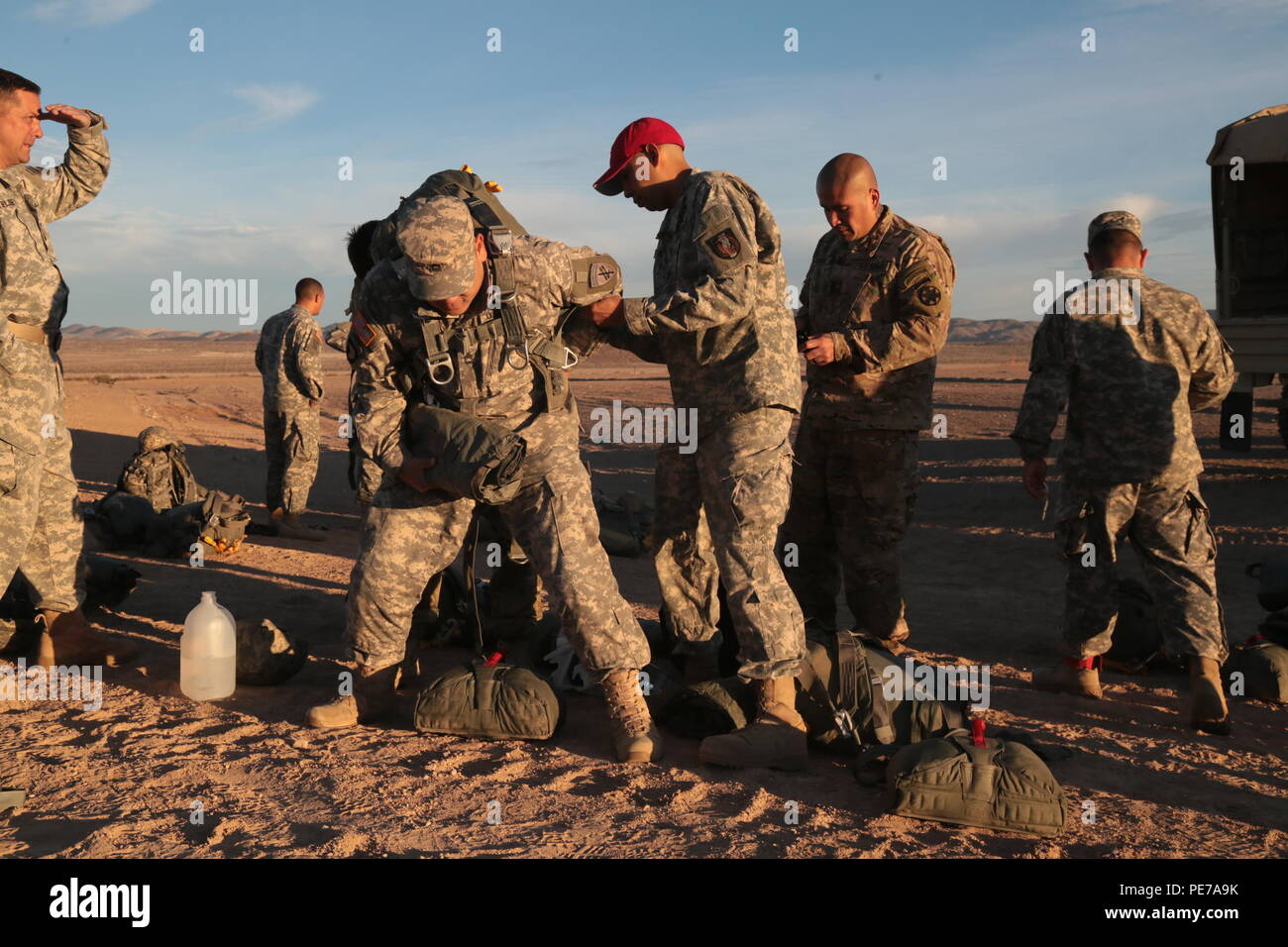 A U.S. Army rigger checks the parachute of a Soldier assigned to ...
