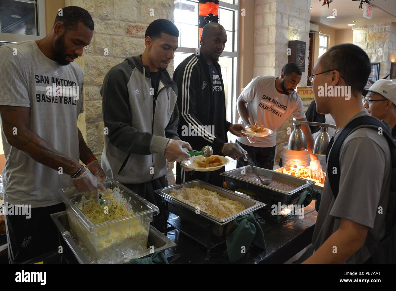 San Antonio Spurs players served lunch at the Warrior and Family