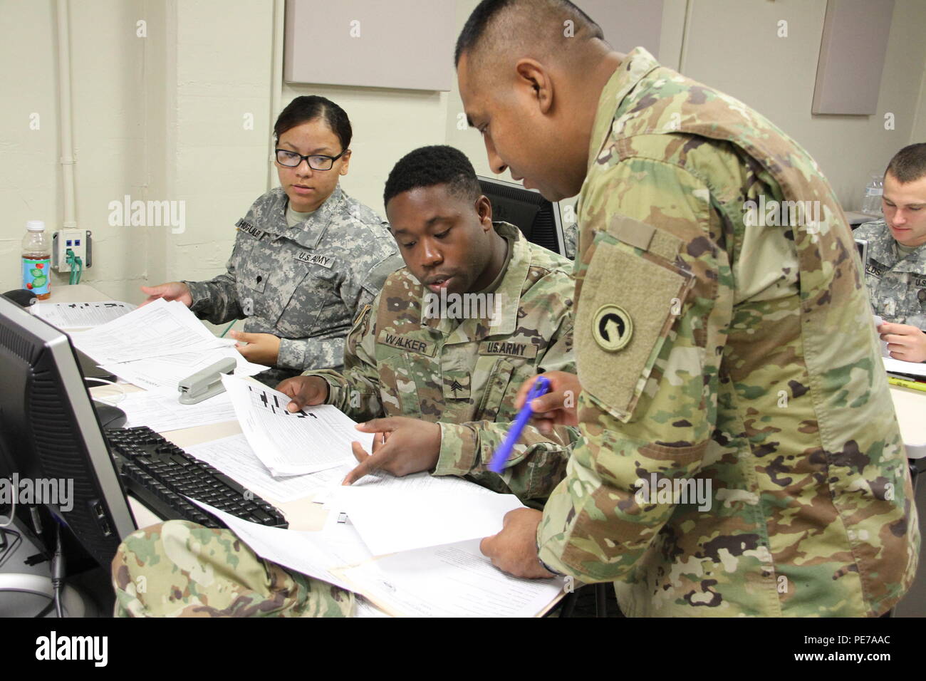 Staff Sgt. Pedro Torres, right, accounting section noncommissioned officer in charge, 18th Financial Management Support Center, 1st Sustainment Command (Theater), gives instructions to Sgt. Hassan Walker, middle, commercial vendor services analyst, and Spc. Kenya Huguley, left, commercial vendor services technician, during a certification exercise Oct. 26 led by U.S. Army Financial Management Command at the XVIII Airborne Corps Headquarters at Fort Bragg, N.C. Stock Photo