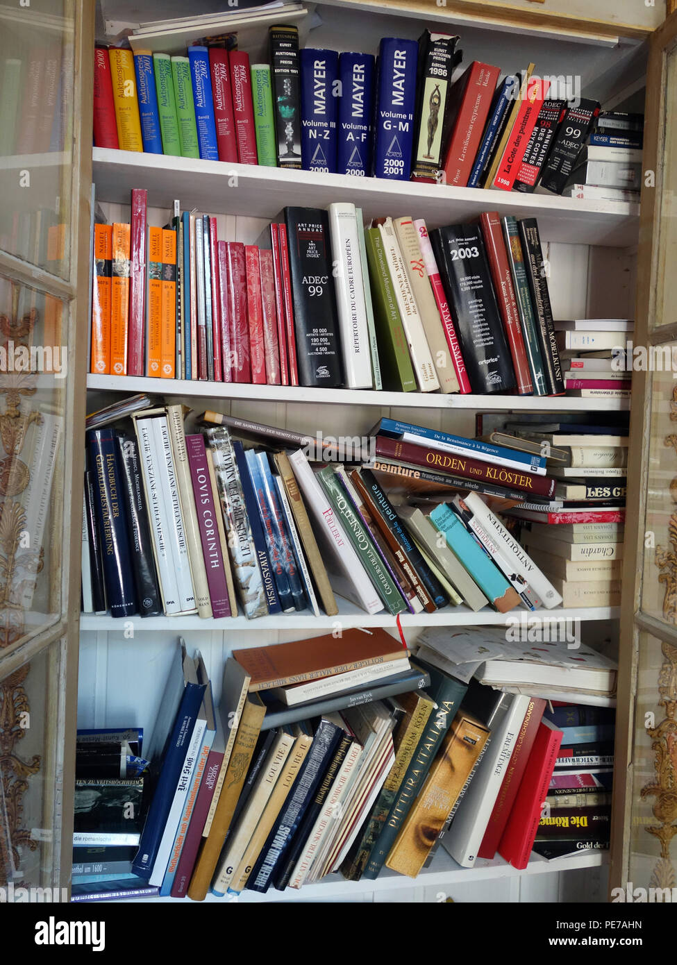 haphazard collection of books badly arranged on book shelf Stock Photo