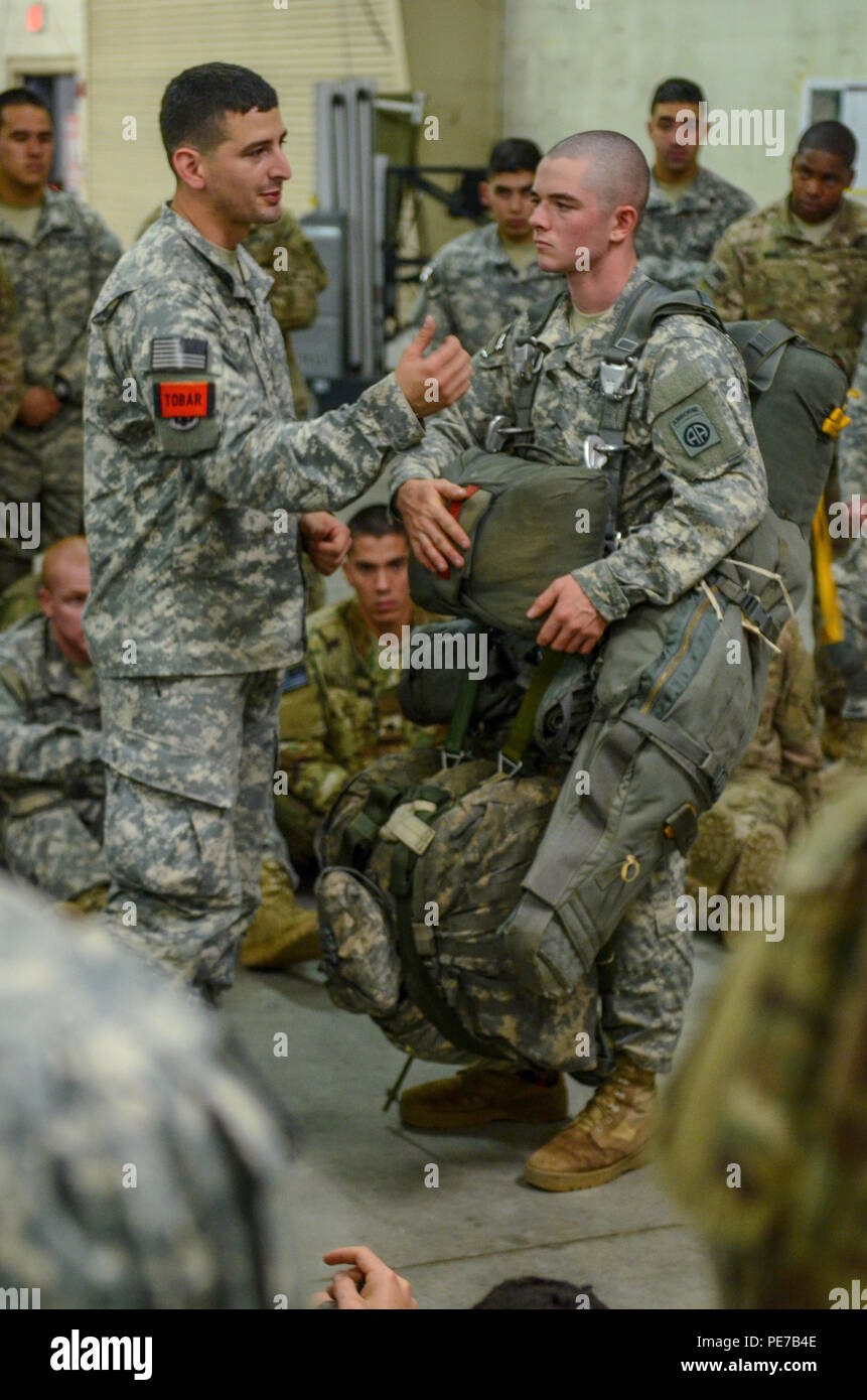 A jumpmaster conducts a brief on how to properly don the parachute, harness and other equipment