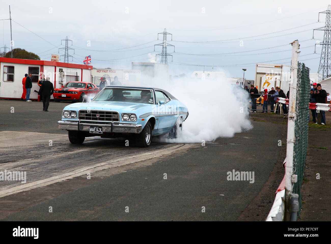 A car performing a wheel spin to warm up the tyres before racing on the drag strip of York Raceway in Melbourne,East Yorkshire Stock Photo