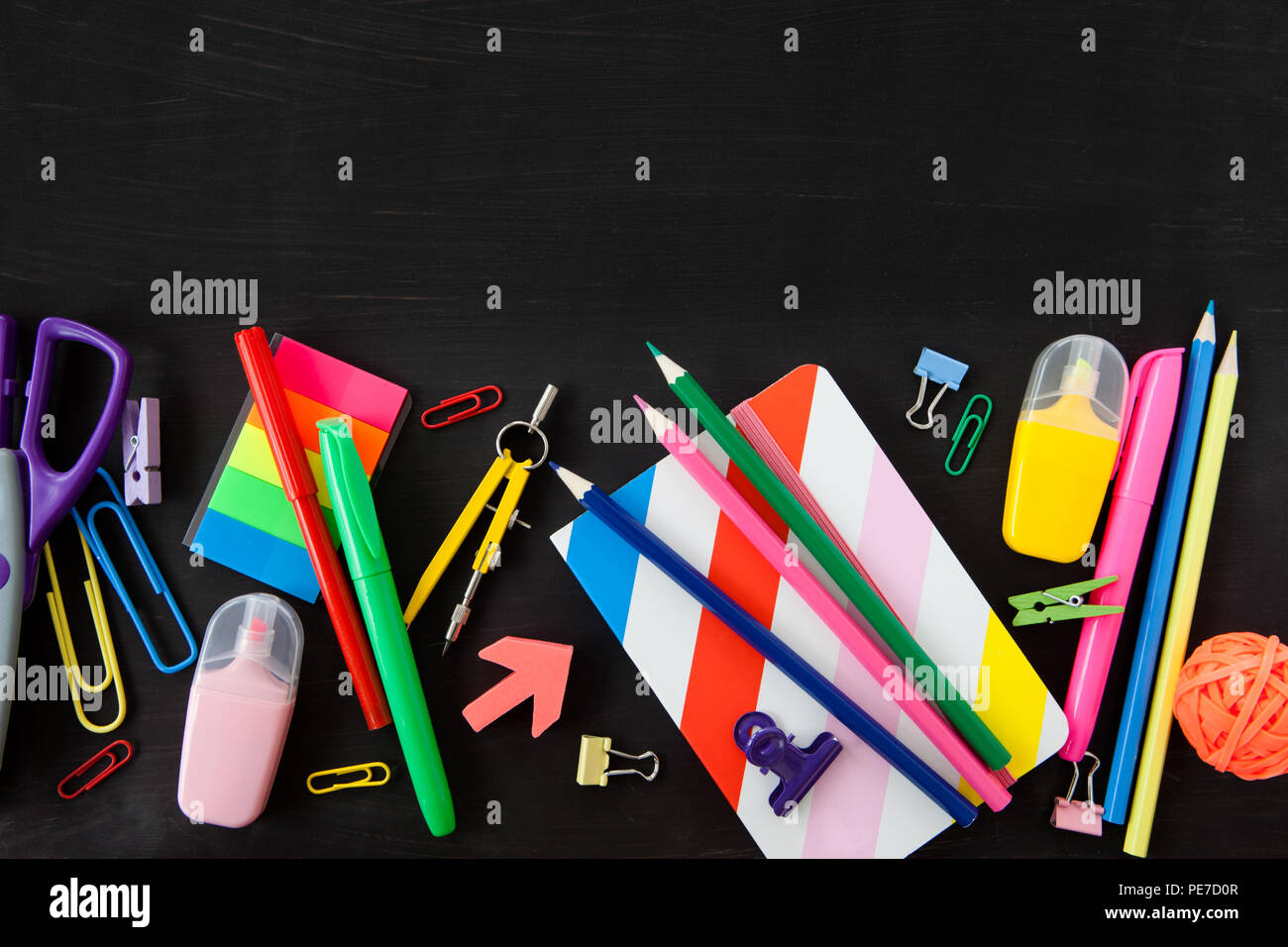 Colorful office / school supplies on a black background Stock Photo