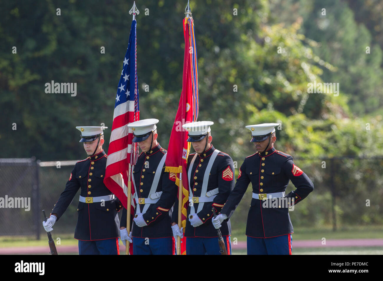 U.S. Marines with the color guard bow their heads during the Joint Daytime Ceremony at Harry B. Liversedge field on Camp Lejeune, N.C., Nov. 6, 2015. The ceremony is held every year in honor of the Marine Corps birthday and includes a historical uniform pageant, rededication of national and U.S. Marine Corps Colors and the traditional birthday cake cutting. (U.S. Marine Corps photo by Ms. Kaitlin Regan, COMCAM, MCI-East, Camp Lejeune/ Released) Stock Photo