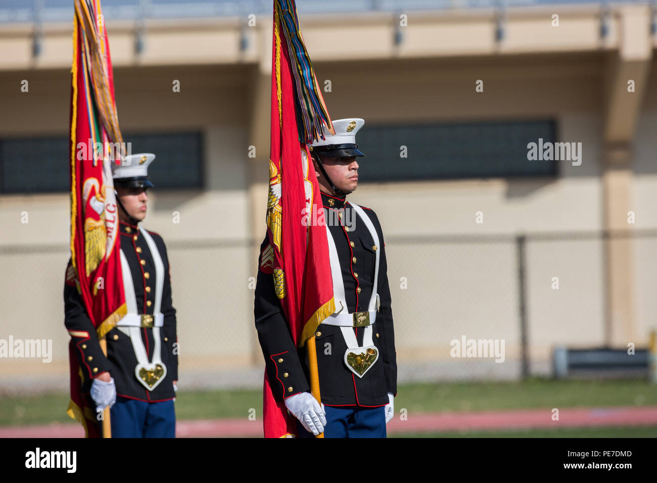 U.S. Marines stand at attention during the Joint Daytime Ceremony at Harry B. Liversedge field on Camp Lejeune, N.C., Nov. 6, 2015. The ceremony is held every year in honor of the Marine Corps birthday and includes a historical uniform pageant, rededication of national and U.S. Marine Corps Colors and the traditional birthday cake cutting. (U.S. Marine Corps photo by Ms. Kaitlin Regan, COMCAM, MCI-East, Camp Lejeune/ Released) Stock Photo