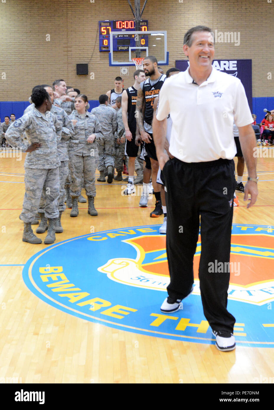 Jeff Hornacek, Phoenix Suns head coach, walks across the court after stating the rules for a half court game Nov. 5, 2015, on Luke Air Force Base, Ariz. Players were matched to Airmen and would have to make a shot from half-court to win the Airmen a personally signed jersey. (U.S. Air Force photo by Staff Sgt. Marcy Copeland) Stock Photo