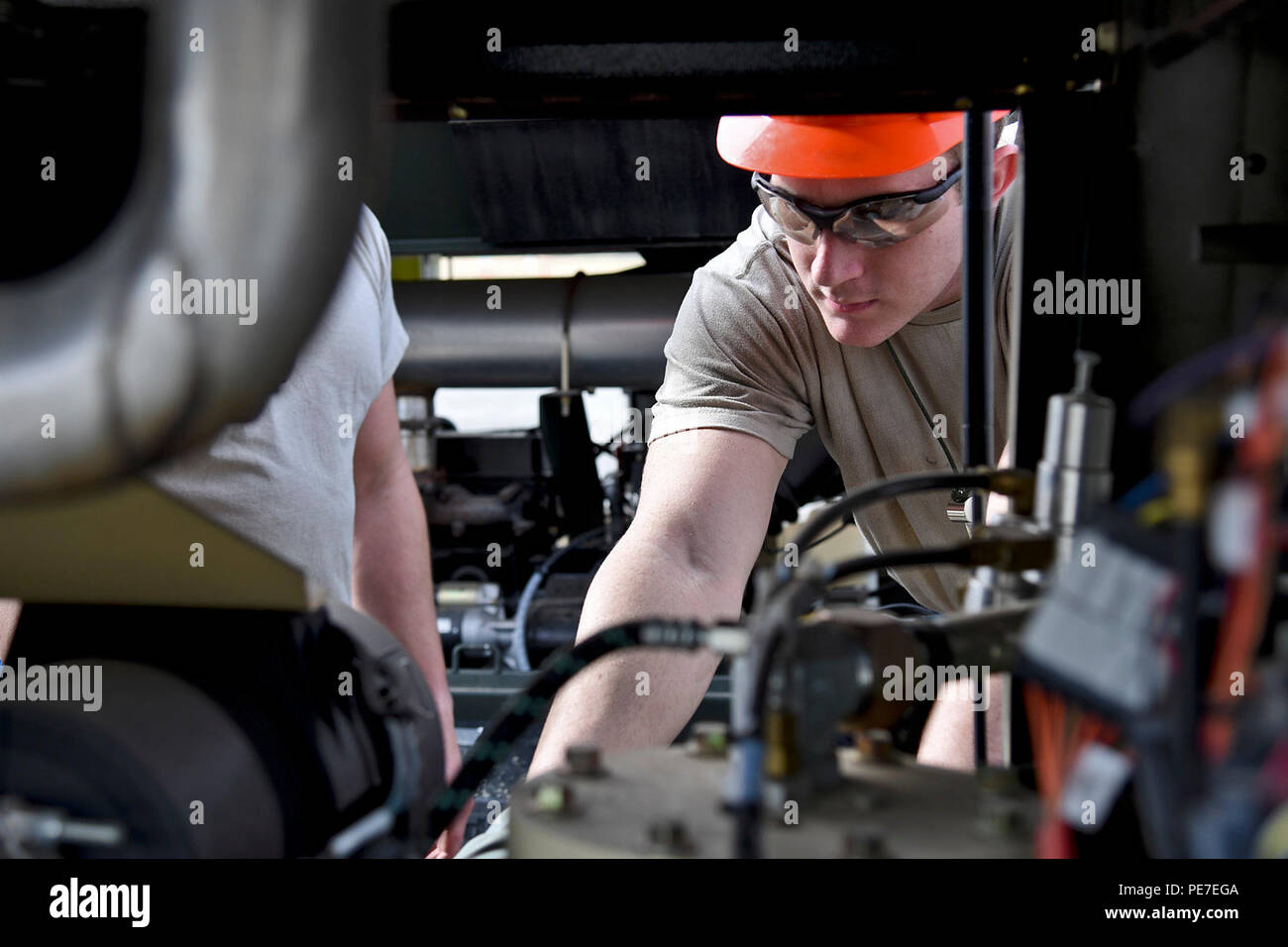 Senior Airman Eric Brown, 92nd Maintenance Squadron aero repair journeyman, conducts the pre-use inspection of the MC-7 air cart, which supplies air to the airbags during the Crash, Damaged, Disabled Aircraft Recovery training lift Oct. 9, 2015, at Fairchild Air Force Base, Wash. The CDDAR proficiency training simulated a scenario in which a KC-135 Stratotanker made contact with the ground without the nose landing gear extending. (U.S. Air Force photo/Airman 1st Class Mackenzie Richardson) Stock Photo