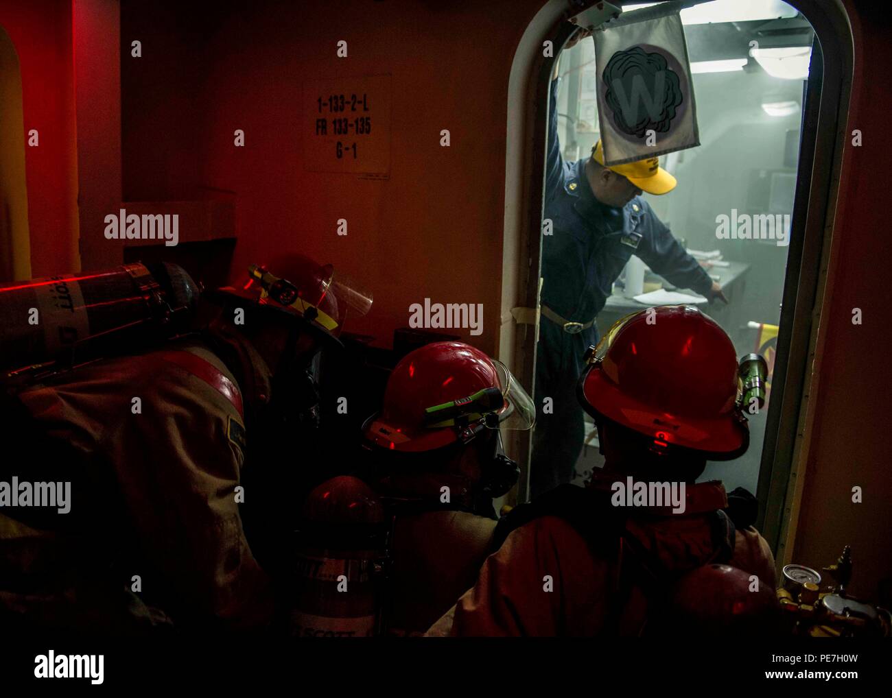 151016-N-IN729-203 WATERS SOUTH OF JAPAN (Oct. 16, 2015) Chief Hospital Corpsman Todd Falcon, from Honolulu, guides Sailors as they simulate fighting a class alpha fire during a general quarters drill aboard the U.S. Navy's only forward-deployed aircraft carrier USS Ronald Reagan (CVN 76). Ronald Reagan and its embarked air wing, Carrier Air Wing (CVW) 5, provide a combat-ready force that protects and defends the collective maritime interests of the U.S. and its allies and partners in the Indo-Asia-Pacific region. (U.S. Navy photo by Mass Communication Specialist 3rd Class Ryan McFarlane/Relea Stock Photo