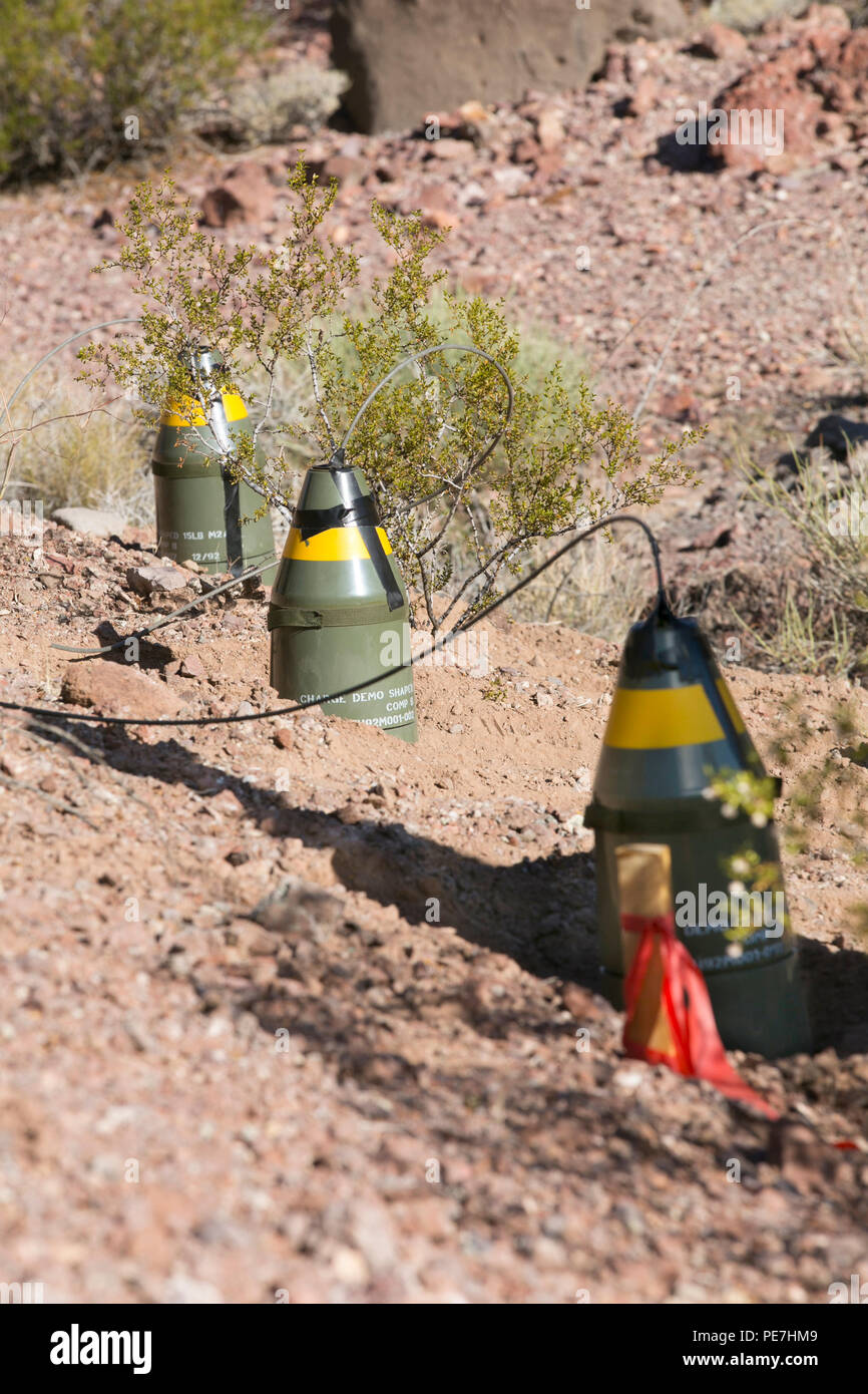 Combat Center Explosive Ordnance Disposal uses three M2A4 shaped charges to create holes for continued excavation during a demolition operation at Rainbow Canyon Training Area, Oct. 8, 2015. Each shaped charge was used to create holes for other explosives to create level ground for wildlife guzzlers to be installed while meeting EOD’s training requirements. (Official Marine Corps photo by Lance Cpl. Thomas Mudd/Released) Stock Photo