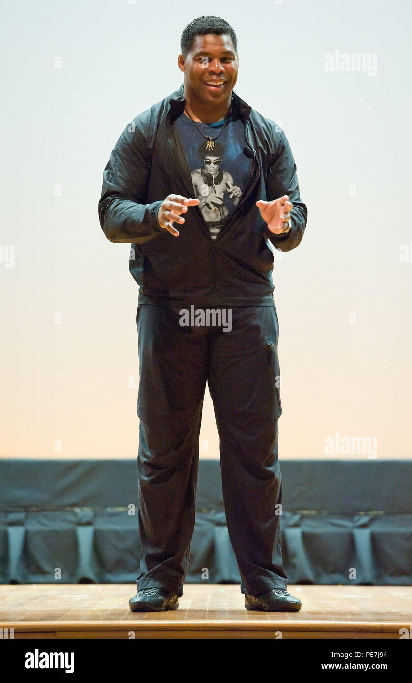 Former NFL running back and 1982 Heisman Trophy winner Herschel Walker speaks to Team Dover members on Wingman Day, Oct. 14, 2015, at the base theater on Dover Air Force Base, Del. The Patriot Support Program’s Anti-stigma campaign and Walker came to spread his message of “There is no shame in getting help. I did.” to Team Dover members during Wingman Day by telling service members their treatment begins at that point for them and their families. (U.S. Air Force photo/Roland Balik) Stock Photo