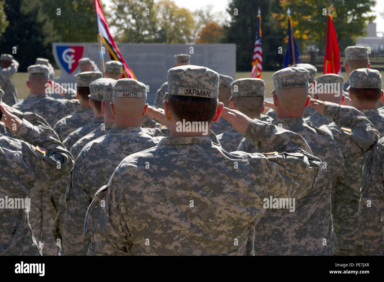 National Guardsmen with the 38th Infantry Division Headquarters and Headquarters Battalion salute the U.S. flag during the playing of the national anthem during the unit’s command change ceremony between outgoing commander, Lt. Col. Walter Finney, and Lt. Col. David Skalon, the battalion’s incoming commander. (Photo by Cadet Emily Abrams) Stock Photo