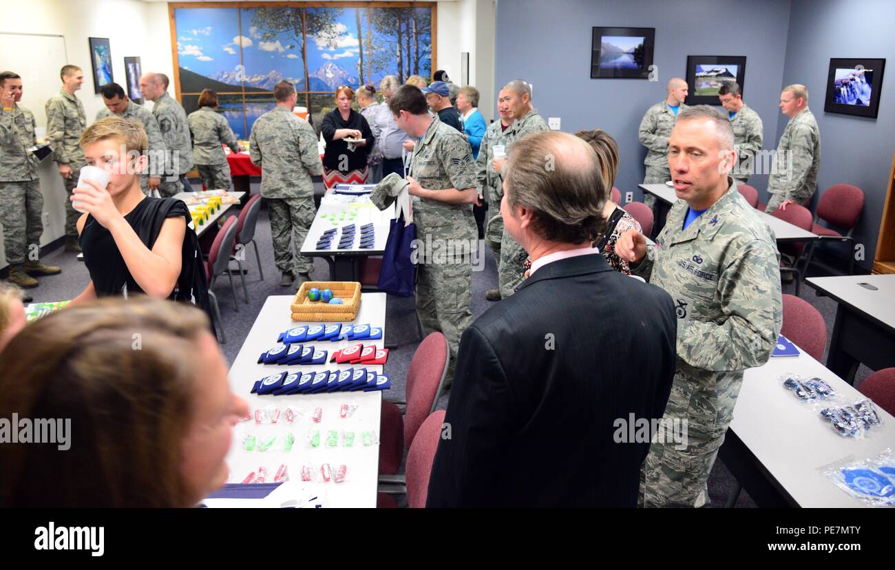 Airmen and their families gather at a reception for the new Airman and