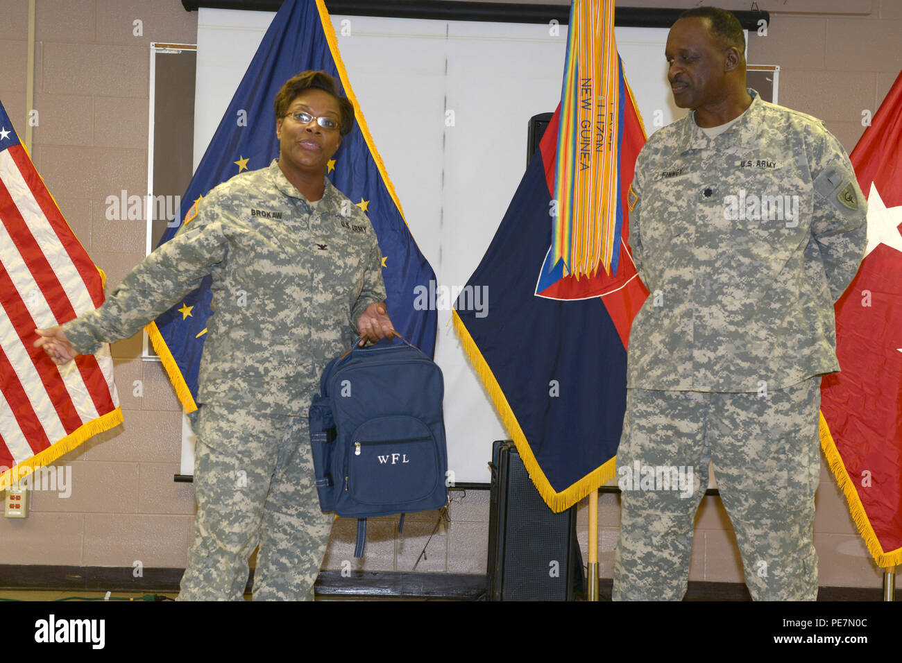 Indiana Army National Guard Col. Felicia Brokaw presents Lt. Col. Walter Finney with a gift during his retirement ceremony at the Cyclone Division Armory in Indianapolis, Saturday, Oct. 17, 2015. Finney retired with 30 years in the Indiana National Guard last serving as the 38th Infantry Division’s headquarters battalion’s commander. (Photo by Sgt. 1st Class Jeff Lowry) Stock Photo