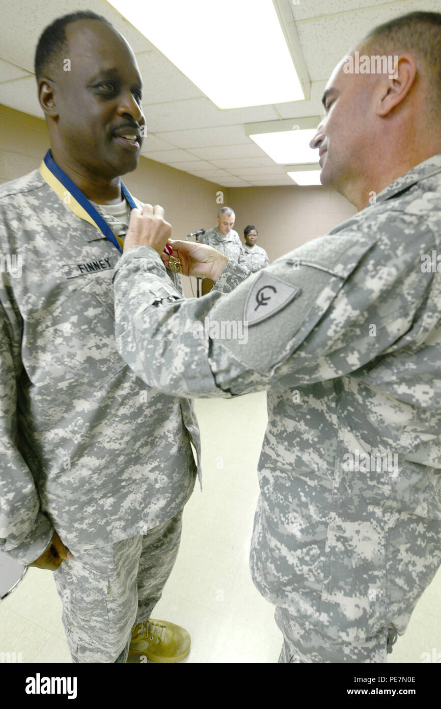 Indiana Army National Guard Lt. Col. Walter Finney receives an interim Meritorious Service Medal from Maj. Gen. David C. Wood, the 38th Infantry Division commanding general, during Finney’s retirement ceremony at the Cyclone Division Headquarters in Indianapolis, Saturday, Oct. 17, 2015. Finney retired with 30 years in the Indiana National Guard last serving as the division’s headquarters battalion’s commander for two years starting in 2013. (Photo by Staff Sgt. Lorne W. Neff) Stock Photo