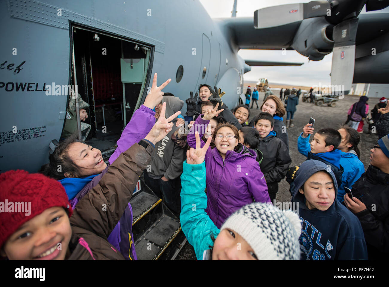 Children in Savoonga, Alaska wait eagerly outside a C130 Hercules