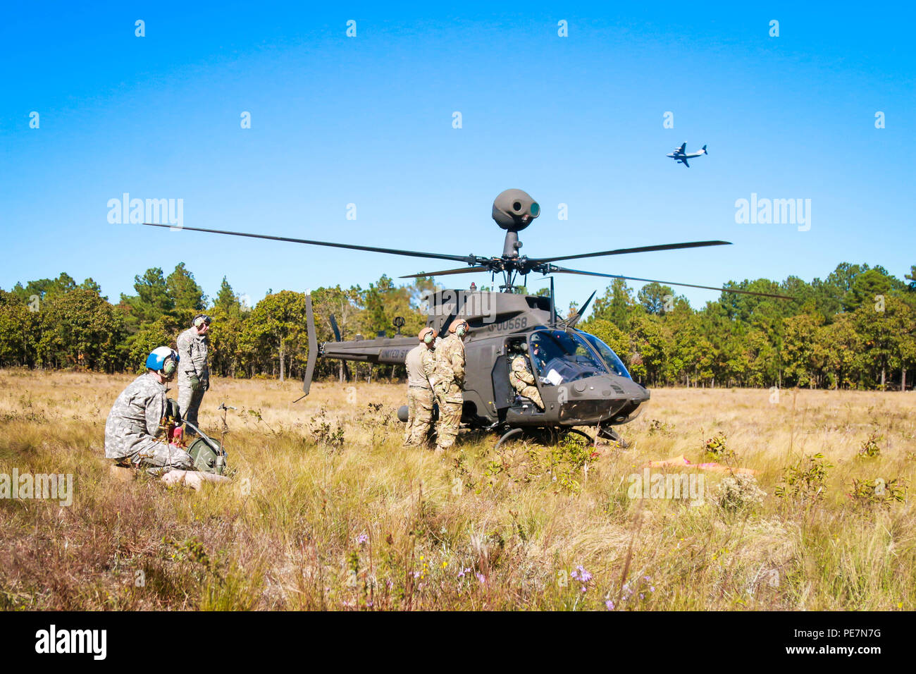 Soldiers refuel and arm an awaiting OH-58 Kiowa Warrior helicopter at the Forward Arming and Refueling Point, during an aerial gunnery exercise, Fort Bragg, N.C., Oct. 19. The FARP is an essential sustainment to ensure aircrafts assigned to the 1st Squadron, 17th Cavalry Regiment, 82nd Combat Aviation Brigade, 82nd Airborne Division, are able to conduct their training. Stock Photo