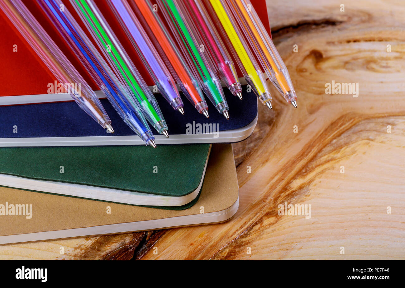 Back to school concept, colored pen and copybook wood background Stock ...