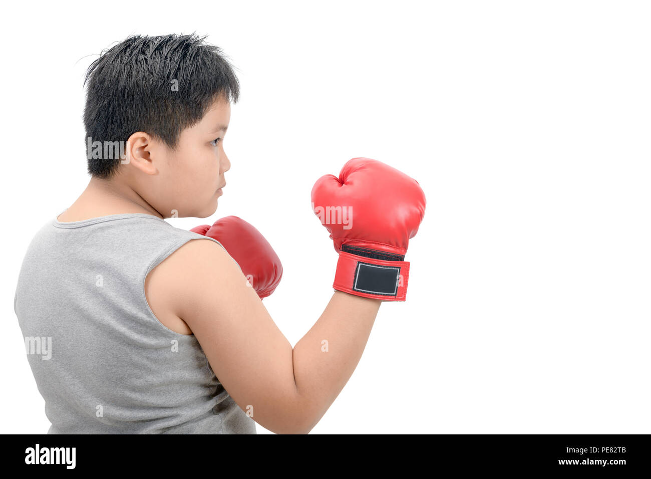 Obese fat boy kid fighting with red boxing gloves isolated on white background, exercise and healthy concept Stock Photo