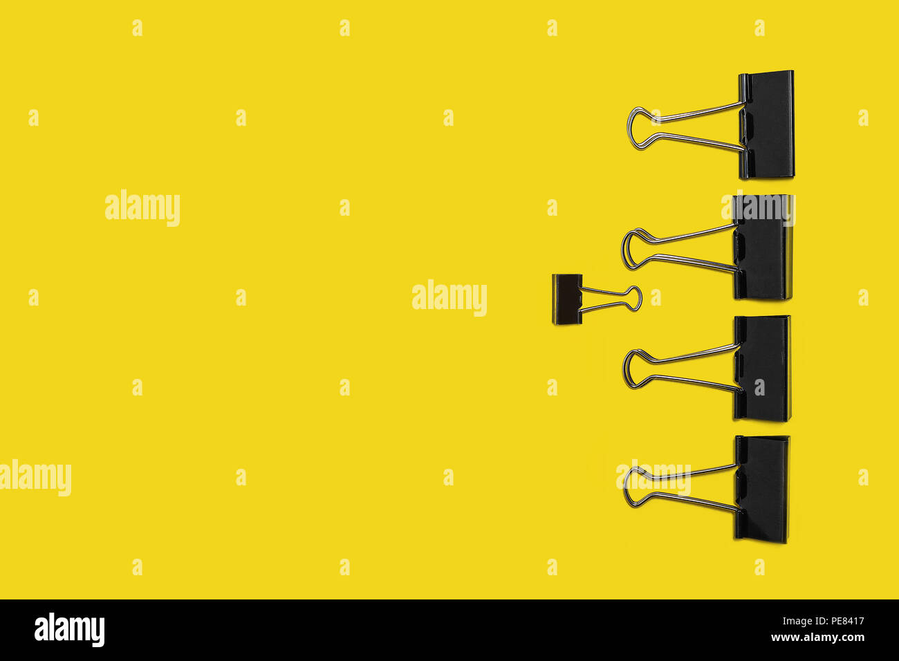 four big paper clips against small one Stock Photo