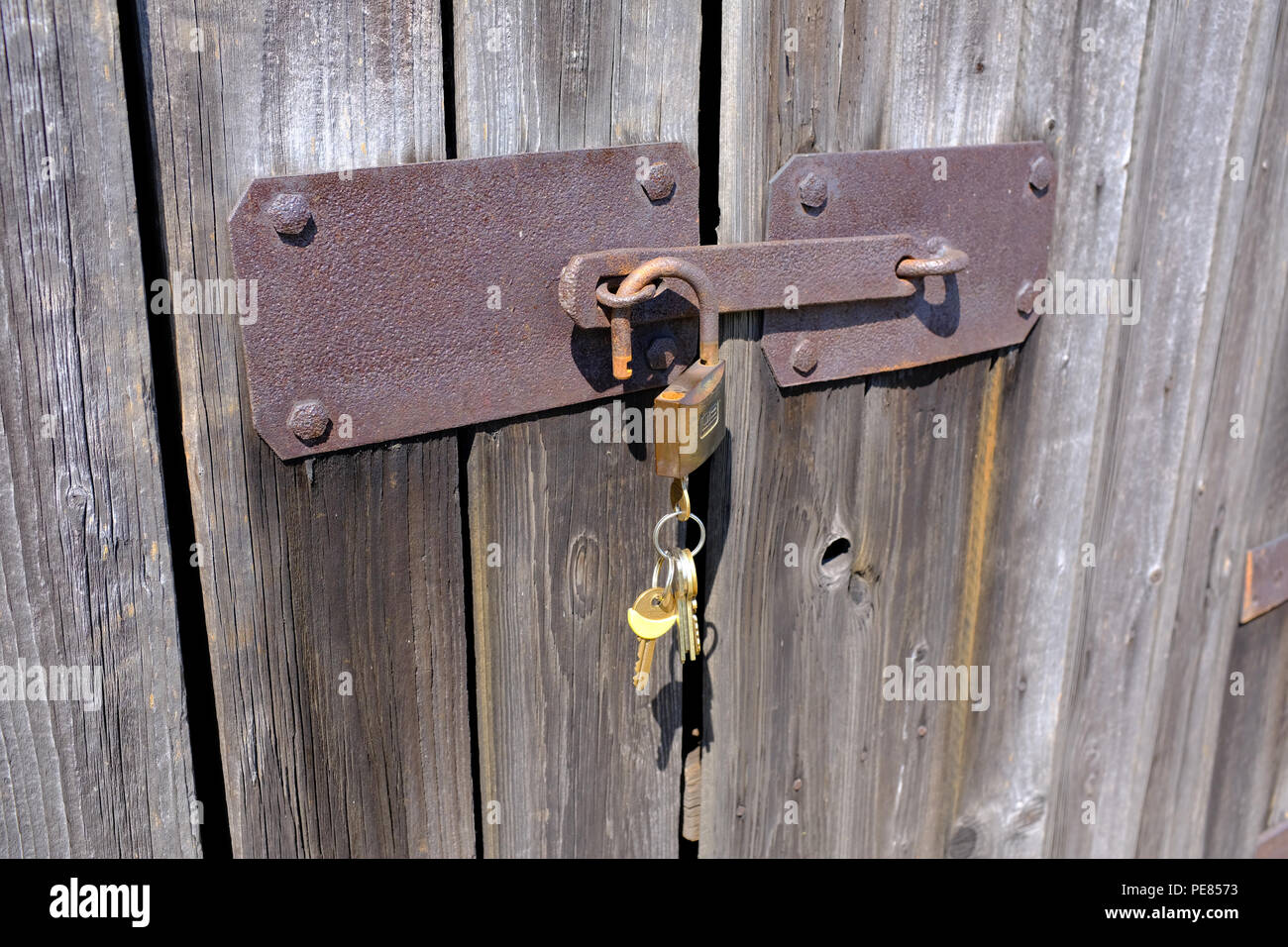 Padlock On Old Barn Door Left Unlocked On A Farm In Poland Stock